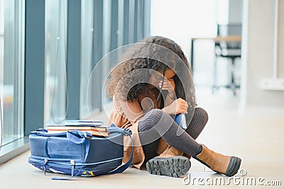 Pupils bullying African-American girl at school. Stop racism Stock Photo