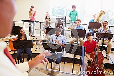 Pupils Playing Musical Instruments In School Orche Stock Photo