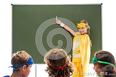 Pupils in superhero costumes Stock Photo