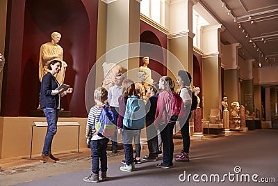 Pupils And Teacher On School Field Trip To Museum With Guide Editorial Stock Photo