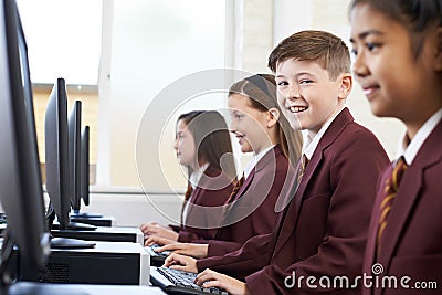 Pupils Wearing School Uniform In Computer Class Stock Photo