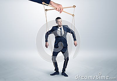 Puppet businessman leaded by a huge hand Stock Photo