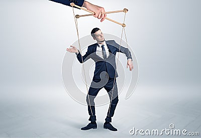 Puppet businessman leaded by a huge hand Stock Photo