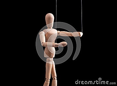 Puppet on strings. Manipulation, control, power, abuse concept. Marionette in human hand. Stock Photo