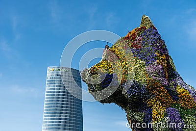 Puppy sculpture kissing Iberdola Tower in Bilbao Editorial Stock Photo