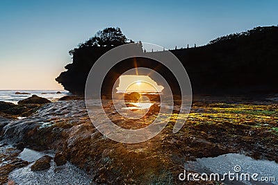 Pura Batu Bolong rock hole on sunset. Stock Photo