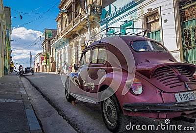 A purble oldtimer beetle in the streets of santiago de cuba Editorial Stock Photo