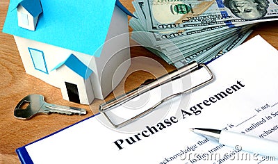 Purchase agreement document with home model. Stock Photo