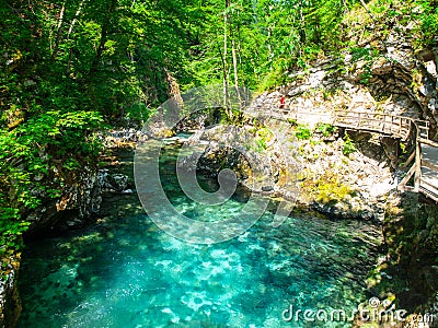 Pure blue water of Radovna river in Vintgar Gorge. Natural waterfalls, pools and rapids and tourist wooden path Stock Photo