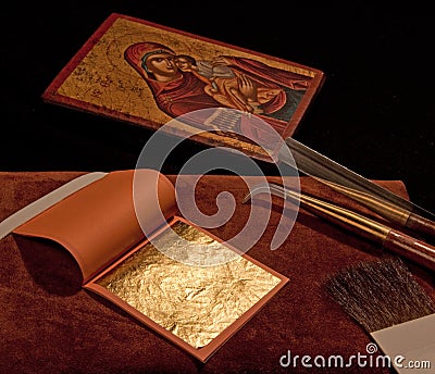 Pure gold leaf with gilding tools and Greek Icon Stock Photo