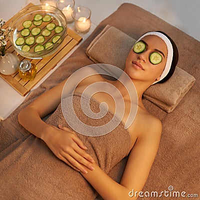 Pure indulgence. A beautiful young woman lying on a massage table at the spa with cucumer over her eyes. Stock Photo