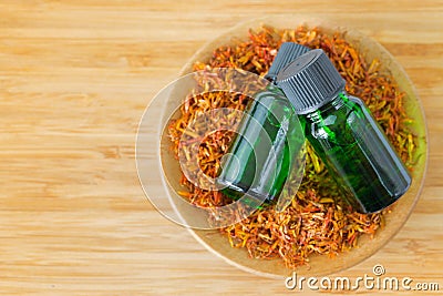 Pure Safflower essential concentrate oil extract in green bottle Stock Photo