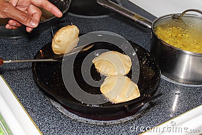 Puri indian food frying in kitchen Stock Photo