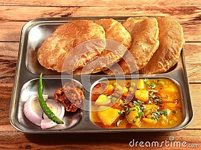 Puri sabji - Indian semi dry Potato Spicy recipe also known as Batata or Aloo ki Sabji, served with fried Poori.selective focus Stock Photo