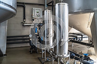 Purified drinking water factory or plant, large iron tanks and water purification filters and automation filtration Stock Photo