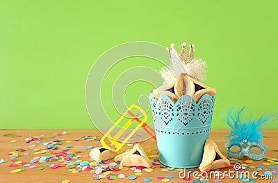 Purim celebration concept jewish carnival holiday over green wooden background Stock Photo