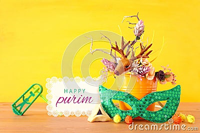 Purim celebration image jewish carnival holiday with traditional hamantasch cookies and deer antlers floral decoration over Stock Photo