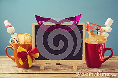Purim holiday background with chalkboard and traditional gifts Stock Photo