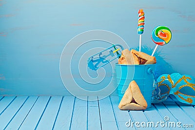 Purim traditional gifts with hamantaschen cookies, noisemaker and carnival mask Stock Photo