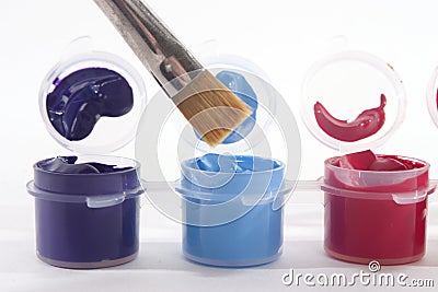 Purple Blue Red Acrylic Paints and Paintbrush Stock Photo