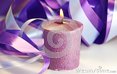 A purple candle is lit. Stock Photo