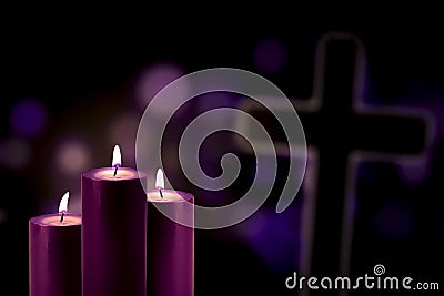 Purple candles with a cross symbol Stock Photo