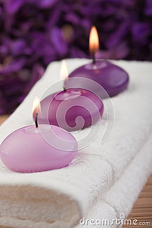 Purple candles on massage towel (2) Stock Photo