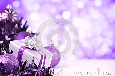 Purple Christmas scene with baubles and gift Stock Photo