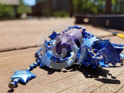 Purple dinosaur with party beads Stock Photo