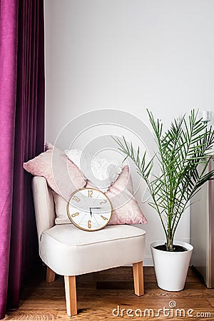 Purple drapes, cozy armchair, pillows and tv stand in living room Stock Photo