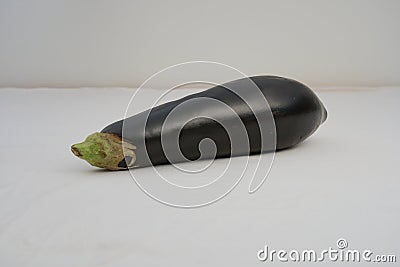 A purple eggplant on white background, a delicious and nutritious aubergine Stock Photo