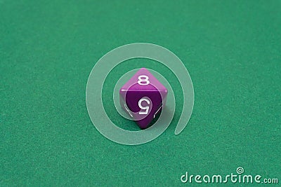 Purple eight sided dice for board games Stock Photo