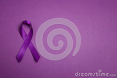 Purple epilepsy awareness ribbon on a purple background with copy space. World epilepsy day Stock Photo