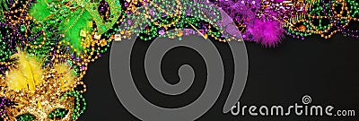 Purple, Gold, and Green Mardi Gras beads and masks Stock Photo