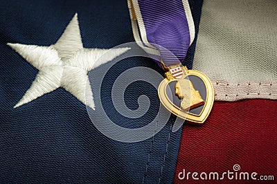 The Purple Heart medal and the American flag Stock Photo