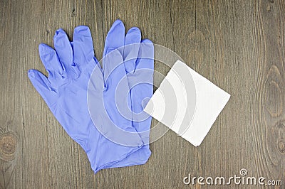 Purple latex gloves and cotton bud on tissue paper Stock Photo