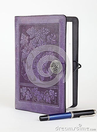 Purple leather bound writing journal and pen Stock Photo