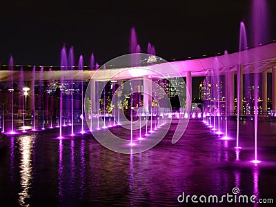 Purple-lighted water fountain at Marina Barrage Stock Photo
