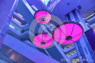 Purple lights shine in commercial building mall Stock Photo