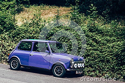 Purple Mini parked on a side of the road in London Editorial Stock Photo