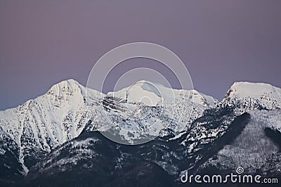 Purple Mountains with Alpine Glow and Snow Stock Photo