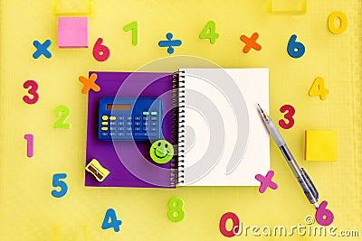 Purple notebook with blank sheet surrounded by numbers and a calculator to learn mathematics Stock Photo