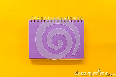 Purple notebook on Yellow background Stock Photo