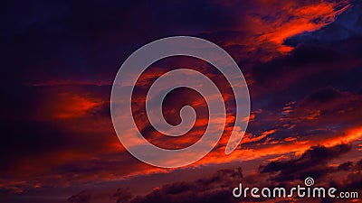 Purple orange sunset. Dramatic evening sky with clouds. Fiery sky background with space for design. Stock Photo
