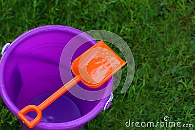 Purple Pail With Orange Shovel Stock Photo