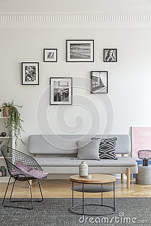 Pillow on stylish metal chair in fashionable living room interior with Scandinavian design Stock Photo