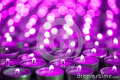 Purple pink candle light. Christmas or Diwali celebration tealight candlelight. Christmas vigil lights Stock Photo