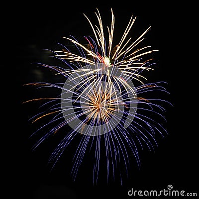 Purple, red, green, and gold fireworks explode during an Independence Day celebration in the United States. Stock Photo