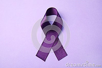 Purple ribbon on lilac background. Domestic violence awareness Stock Photo