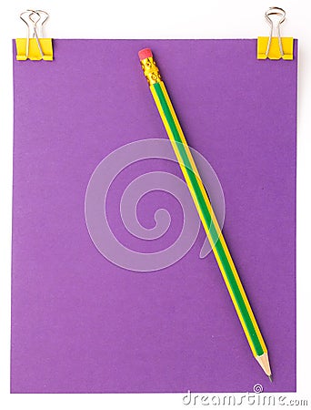 Purple sheet of paper with yellow paper clip and pencil Stock Photo